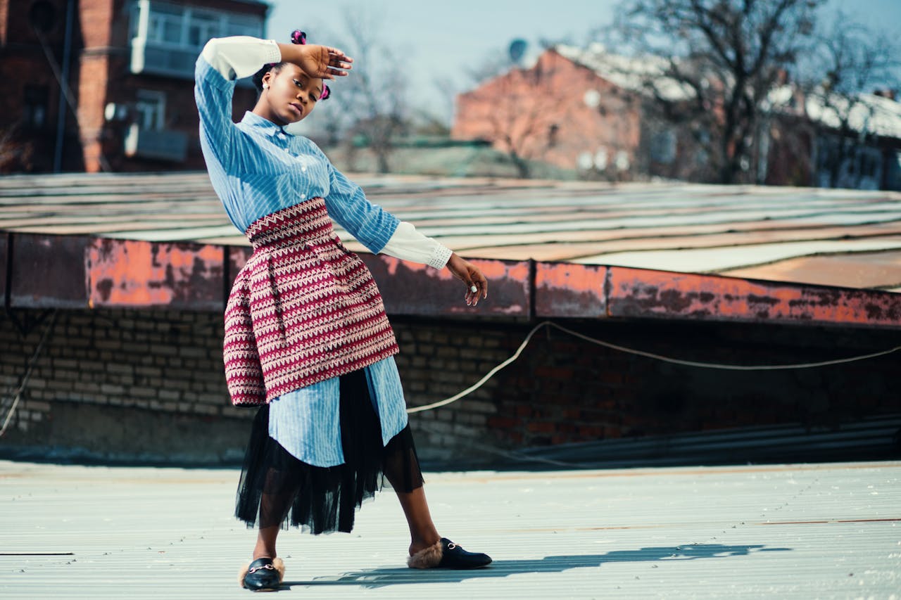 Home Fashionable woman posing on a rooftop. Creative urban style captured outdoors.